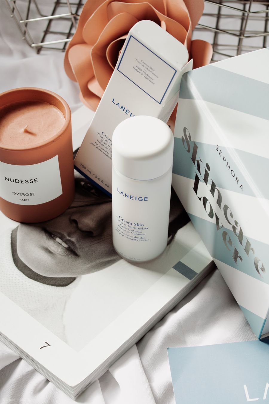 A curated arrangement of skincare products including serum bottles, cleansers and a moisturiser on a neutral surface